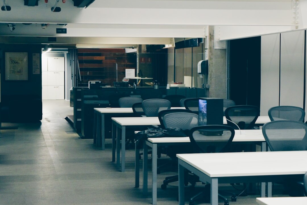Rows of desks in a bright open-plan editorial office